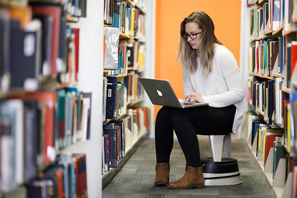 A student on her laptop in the Auraria Library.