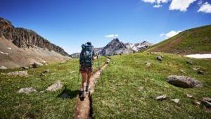 A person who is on a backpacking trip in the mountains.